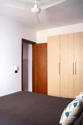 a bedroom with a bed and a wooden cabinet at Porto Antigo 2 - Apt 54 in Santa Maria