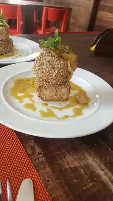 two plates of food on a wooden table at Casa Café Mindelo in Mindelo