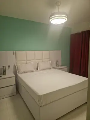 a large white bed in a room with a red curtain at SUITES-HOME, CIDADELA in Praia