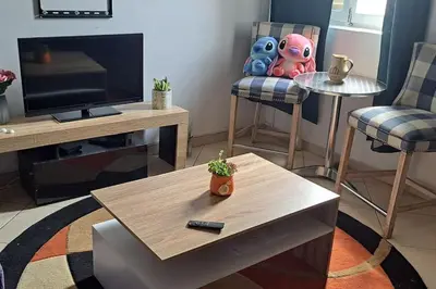 a living room with a coffee table and a tv at Mendes Family Homestay - B&B In The Heart Of Praia in Praia