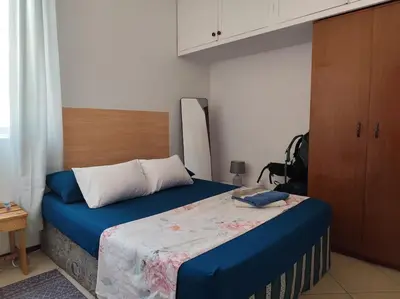a bedroom with a bed with blue sheets and white pillows at Mendes Family Homestay - B&B In The Heart Of Praia in Praia