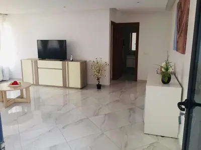 a living room with a television and a tiled floor at Residencial Santo Amaro in Tarrafal