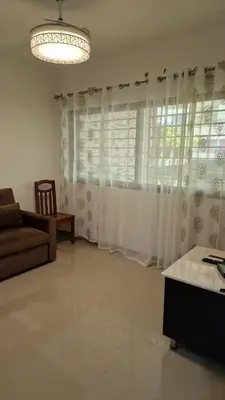 a living room with a couch and a window at SUITES-HOME, CIDADELA in Praia