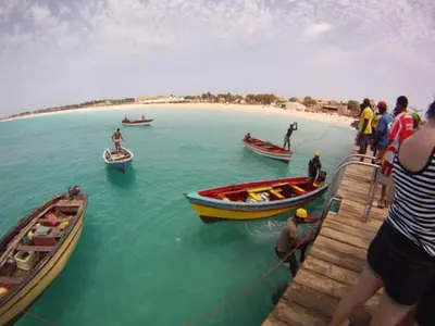 a group of people on a dock with boats in the water at Casa Bahia 5 in Santa Maria
