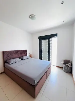 a bedroom with a large bed in a white room at Bliss Apartments T1 - Adélia in Mindelo