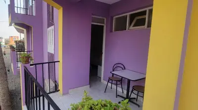 a colorful house with a table and chairs on a balcony at OpenSky in São Filipe
