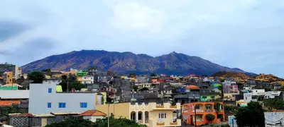 a view of a city with a mountain in the background at OpenSky in São Filipe