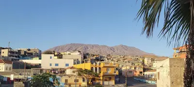 a view of a city with a mountain in the background at OpenSky in São Filipe