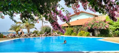 a person in the swimming pool at a resort at Apartamento Porto Antigo 2 in Santa Maria