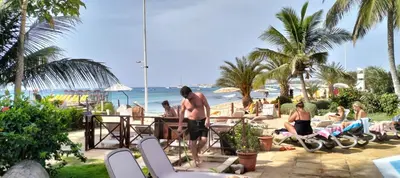 a group of people sitting on chairs at the beach at Apartamento Porto Antigo 2 in Santa Maria