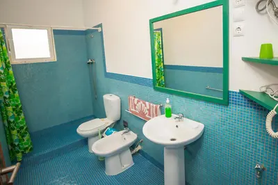 a bathroom with two toilets and a sink and a mirror at Appartamento LULA. Stella Maris Exclusive in Calheta Do Maio
