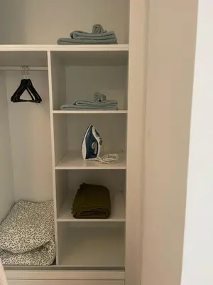 a white book shelf in a bedroom at Ocean View Santa Filomena in Mindelo