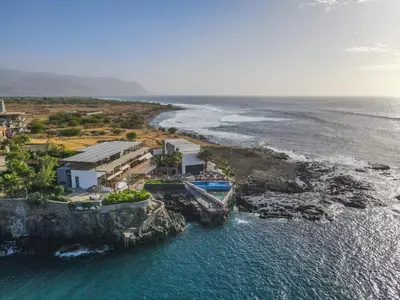 an aerial view of a house next to the ocean at King Fisher Village Eco-Boutique Hotel in Tarrafal