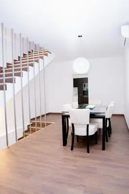 a dining room with a table and white chairs at Villa Santiago in Praia