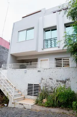 a white house with stairs in front of it at Nhu Sao Francisco - PALMAREJO T3 in Praia