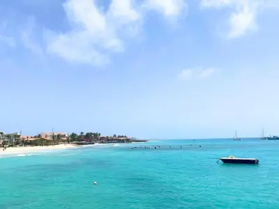 a boat in the water near a beach at Studio Apt Bounty Condominium, Santa Maria in Santa Maria