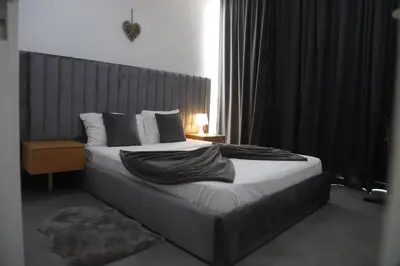 a bedroom with a large bed with a large window at Maison da Praia in Praia