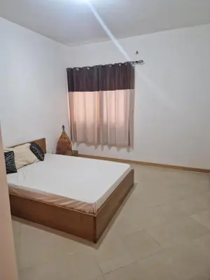 a bedroom with a bed and a window at Condomínio palma azul II in Praia