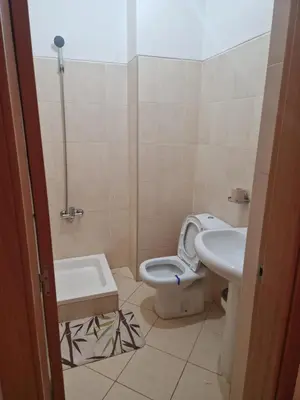 a bathroom with a toilet and a sink at Condomínio palma azul II in Praia