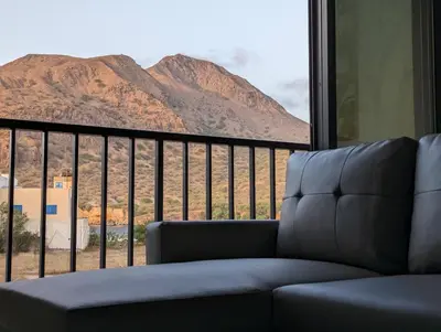 a couch in a room with a view of a mountain at Tarrafal Bay - 1Bdr Apt - Sea view -1 in Tarrafal