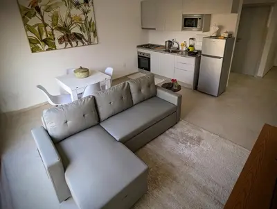 a living room with a couch and a kitchen at Tarrafal Bay - 1Bdr Apt - Sea view - 2 in Tarrafal