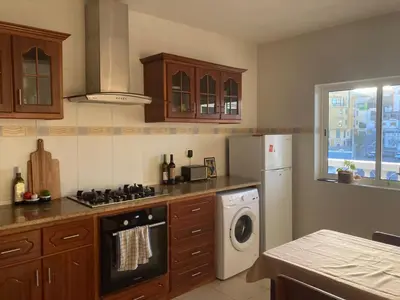 a kitchen with a stove top oven next to a dishwasher at Casa Sofia in Mindelo