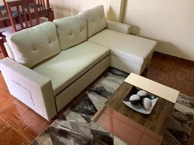 a living room with a white couch and a table at Ramos Apartamento in São Filipe