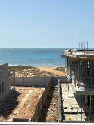 a building under construction next to the ocean at Penthouse with Panoramic Ocean Views and unlimited WiFi in Santa Maria