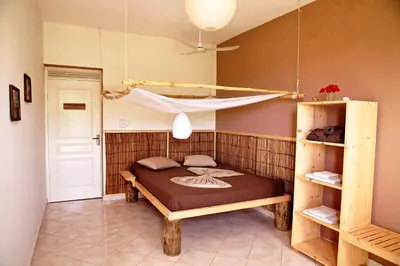 a bedroom with a bed with a hammock in it at Casa Strela B&B Tarrafal in Tarrafal