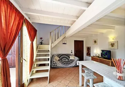 a room with a staircase leading to a bedroom at Beautiful loft in Porto Antigo 1 in Santa Maria