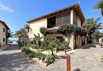 a building with a lot of plants in front of it at Beautiful loft in Porto Antigo 1 in Santa Maria