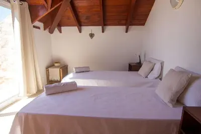a bedroom with two beds and a large window at Calma de Sal Santana Ocean View Apartment in Santa Maria