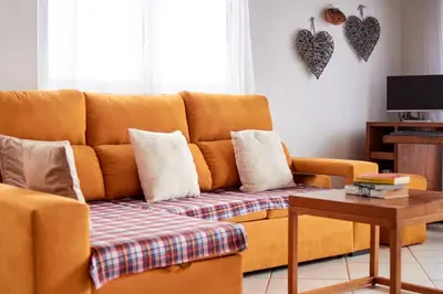 a living room with a couch and a table at Calma de Sal Santana Ocean View Apartment in Santa Maria