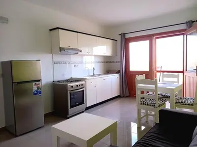 a kitchen with a stainless steel refrigerator and a stove at Apartamento em Santa Maria- Espaçoso&Confortável in Santa Maria
