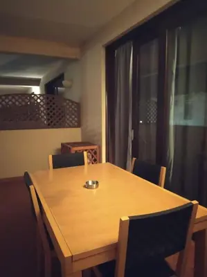 a wooden table and chairs in a room with a window at Apartament in Porto Antigo 2 - Santa Maria in Santa Maria