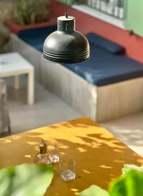 a lamp hanging over a table with glasses on it at Boutique Apartments Ibiscus in Santa Maria