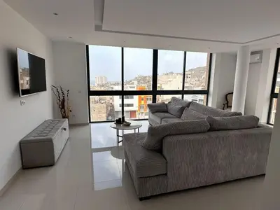 a large living room with a couch and a table at Sharksproperties Apartment in Mindelo