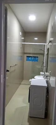 a bathroom with a shower and a sink and a mirror at Apartamento T1 Mobilado Espargos/Sal in Espargos