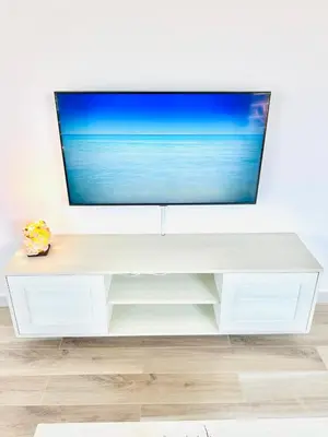 a white entertainment center with a flat screen tv on top at Ocean Breeze 9 in Sal Rei