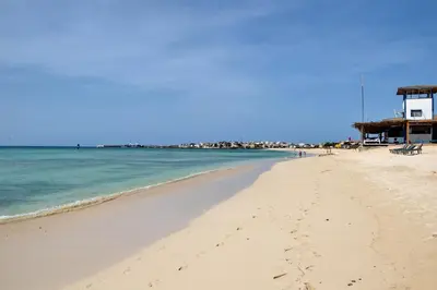 a beach with footprints in the sand and the ocean at WEYt1 in Sal Rei