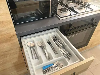 a drawer in a kitchen with silver utensils at Atlantic SAL - One Bedroom Apt in Santa Maria