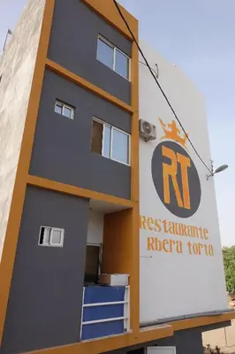 a building with a sign on the side of it at Residencial Ribeira Torta in Porto Novo