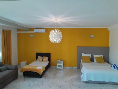 a living room with two beds and a couch at Hotel Xinte na casa in Tarrafal