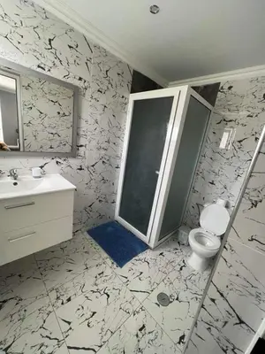 a bathroom with a toilet and a sink and a mirror at Hotel Xinte na casa in Tarrafal