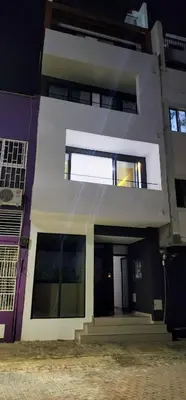 a large white house with a window on it at ACG Plato Terrace & Balcony Apartments in Praia