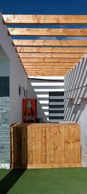 a room with a table and a wooden ceiling at Residência Águia in Praia