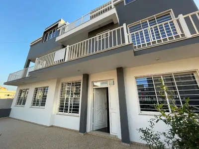 a house with a balcony on top of it at Villa RESIDENCIAL EUNICE in Praia