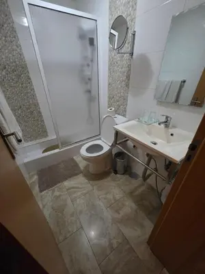 a bathroom with a shower and a toilet and a sink at Djeu View in Praia