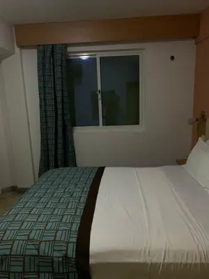 a bedroom with a large bed with a window at Djeu View in Praia