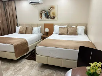 a hotel room with two beds and a table at Djeu View in Praia